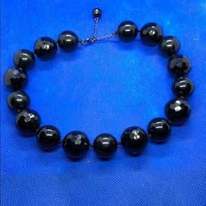 Black round glass necklace.